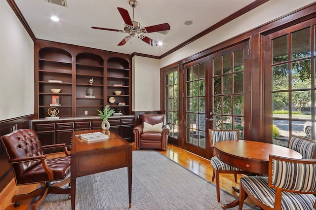 office area featuring plenty of natural light, ornamental molding, and light wood-type flooring