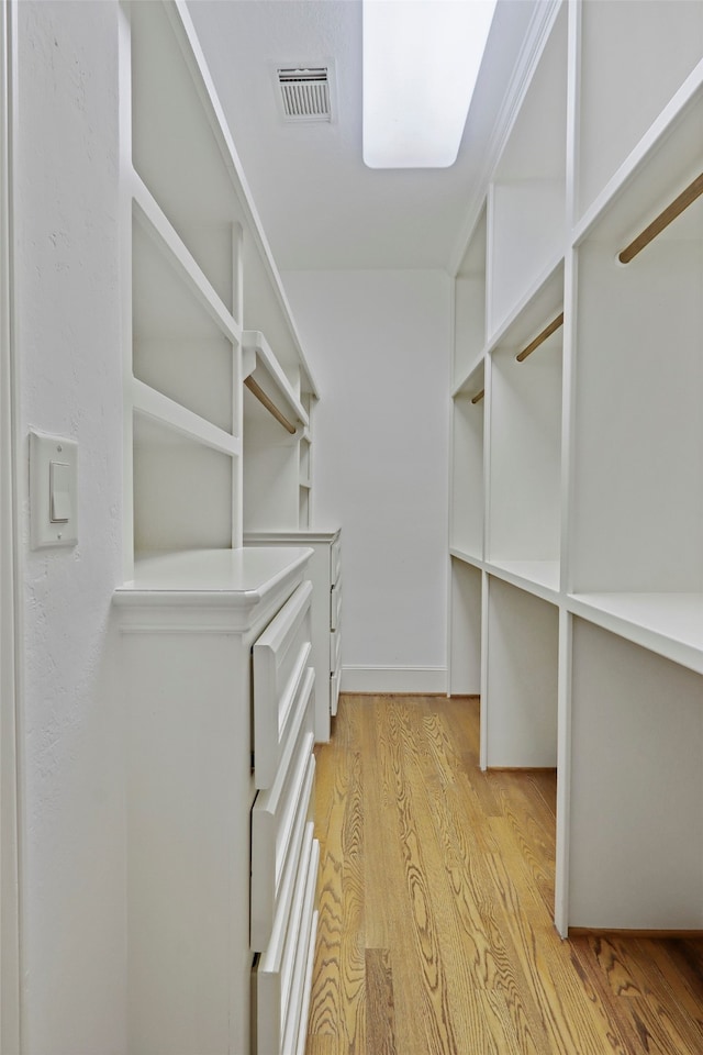 walk in closet featuring light hardwood / wood-style floors