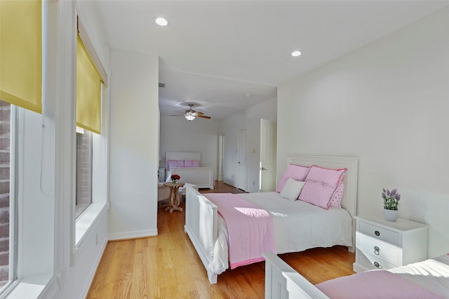 bedroom with ceiling fan and light hardwood / wood-style flooring