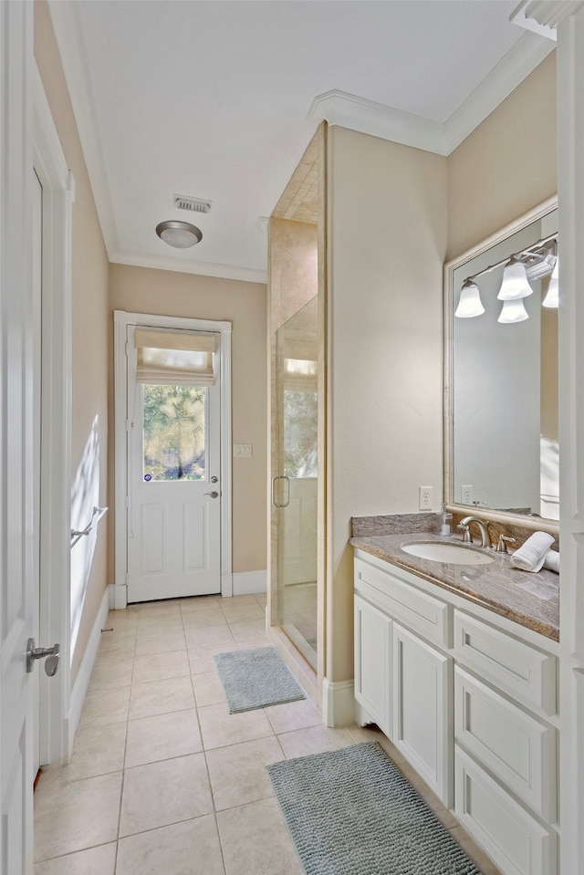 bathroom featuring vanity, crown molding, tile patterned flooring, and walk in shower