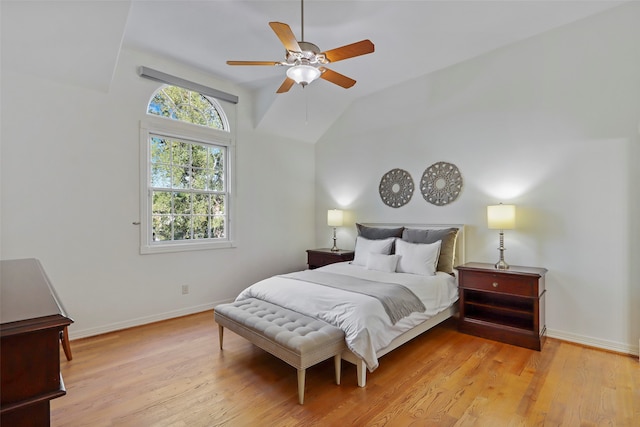 bedroom featuring vaulted ceiling, light wood-type flooring, and ceiling fan