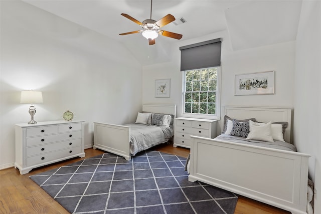 bedroom with lofted ceiling, dark hardwood / wood-style floors, and ceiling fan