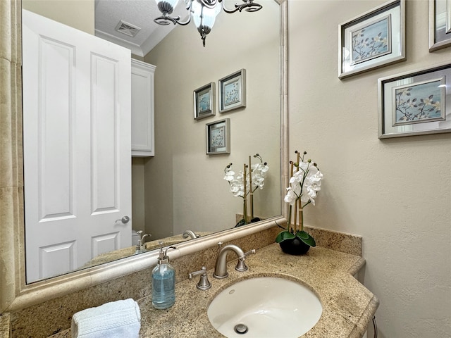 bathroom with vanity and a textured ceiling