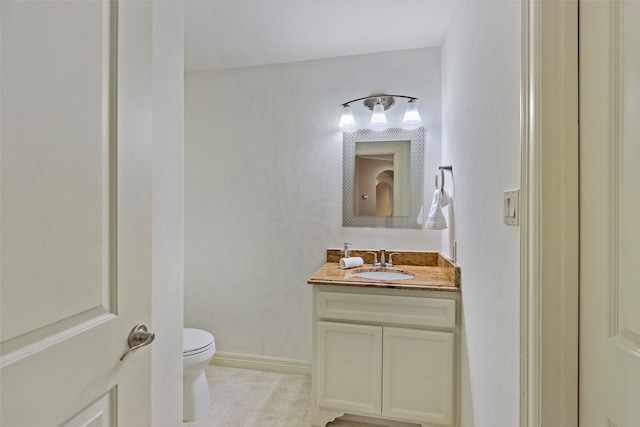 bathroom with vanity, toilet, and tile patterned floors