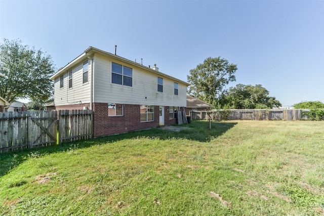 rear view of property featuring a yard