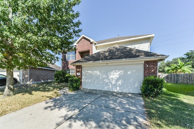 front facade featuring a garage and a front yard