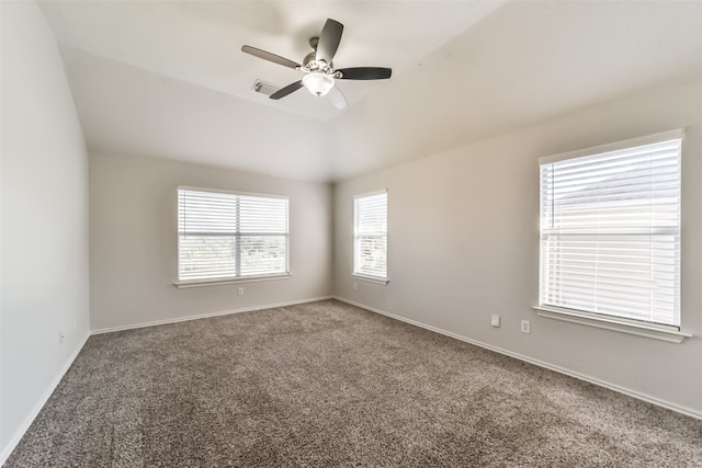 carpeted empty room featuring vaulted ceiling and ceiling fan