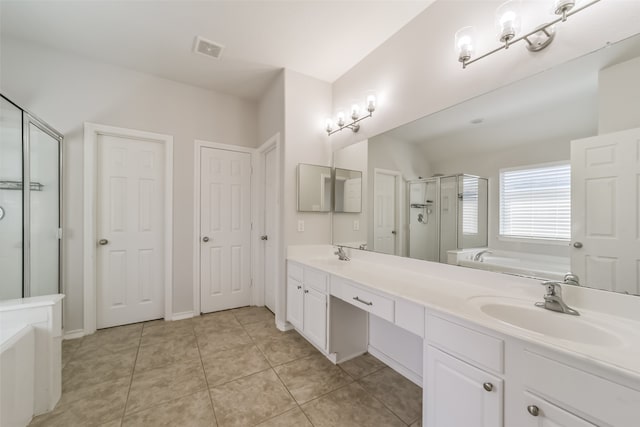 bathroom featuring vanity, plus walk in shower, and tile patterned floors