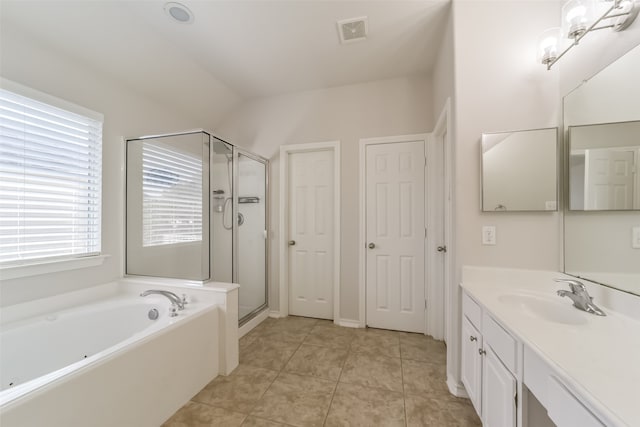 bathroom with plus walk in shower, lofted ceiling, vanity, and tile patterned floors