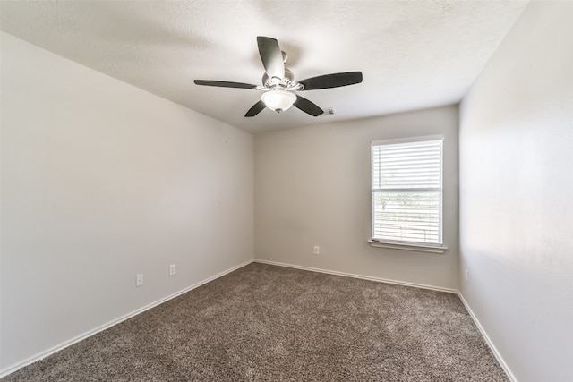 carpeted empty room with ceiling fan and a textured ceiling