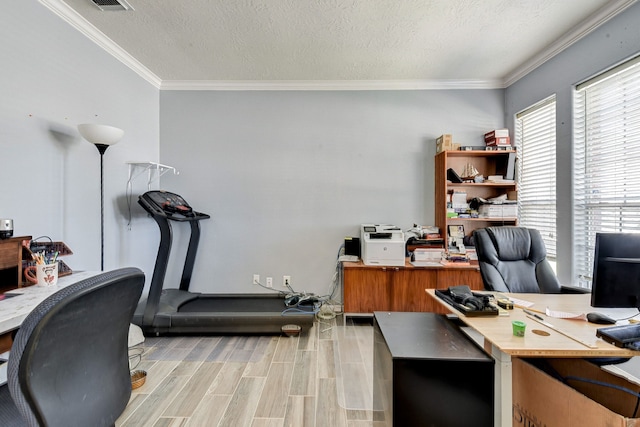 home office with ornamental molding, light hardwood / wood-style floors, and a textured ceiling