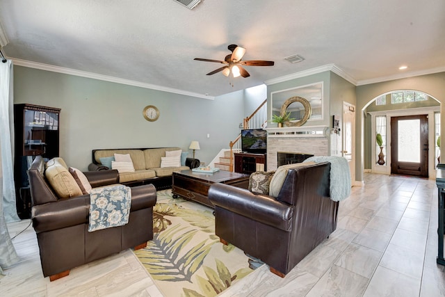 living room with ornamental molding and ceiling fan