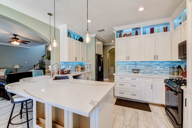 kitchen featuring ceiling fan, white cabinets, sink, and black appliances