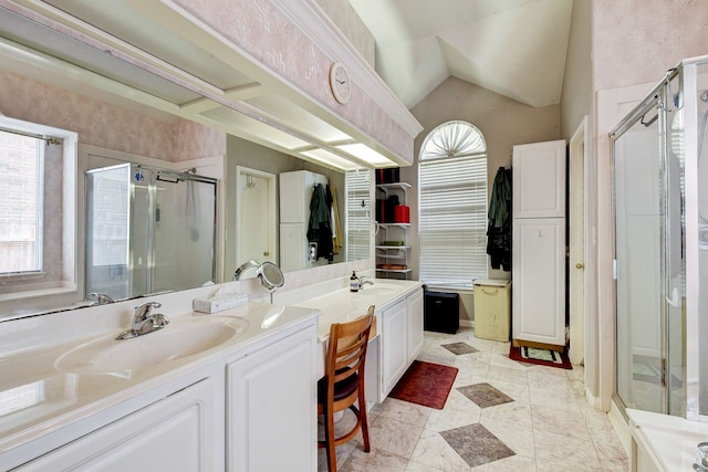 bathroom featuring tile patterned flooring, vanity, lofted ceiling, and an enclosed shower