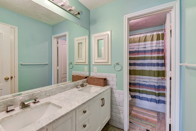 bathroom with tile walls, a shower with curtain, a textured ceiling, and vanity