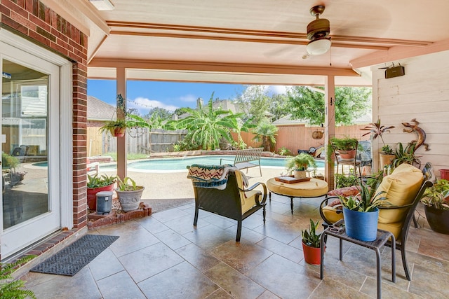 view of patio / terrace with ceiling fan and a fenced in pool