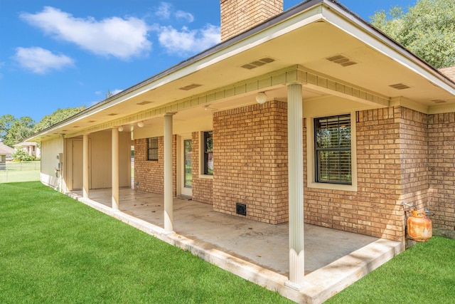 back of house featuring a yard and a patio area