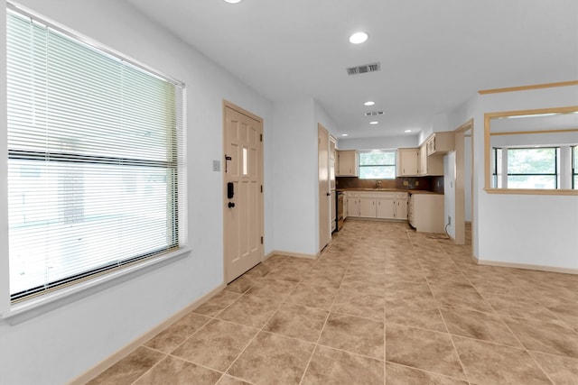 kitchen with light tile patterned floors and sink