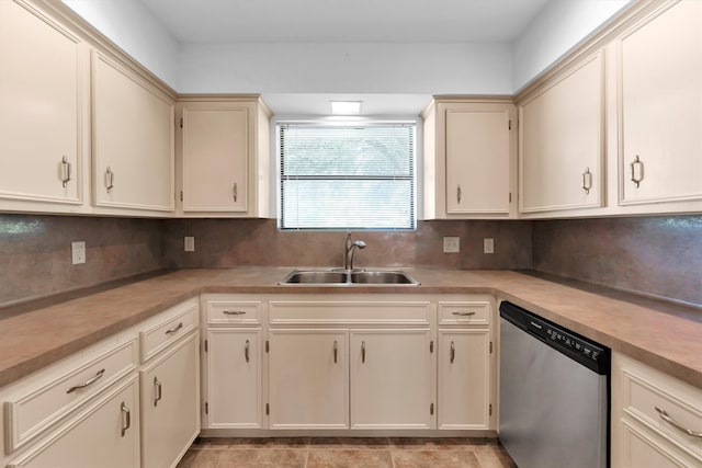 kitchen with backsplash, stainless steel dishwasher, cream cabinets, and sink