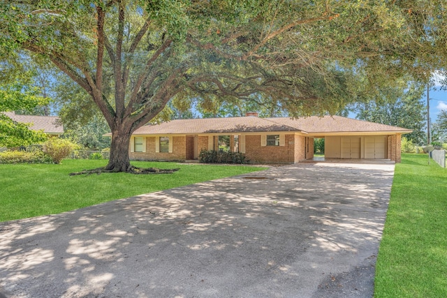 ranch-style home featuring a garage and a front lawn