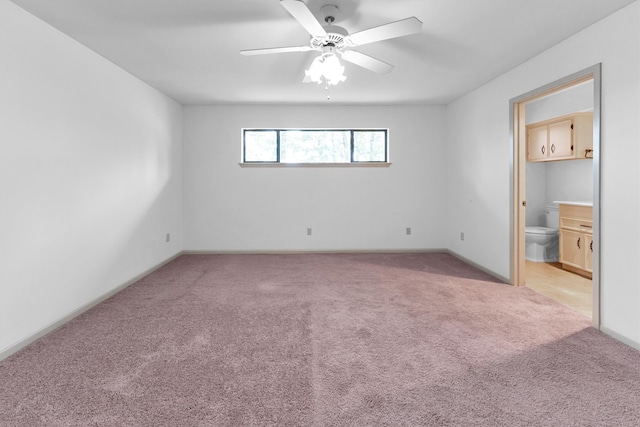 empty room featuring ceiling fan and light colored carpet