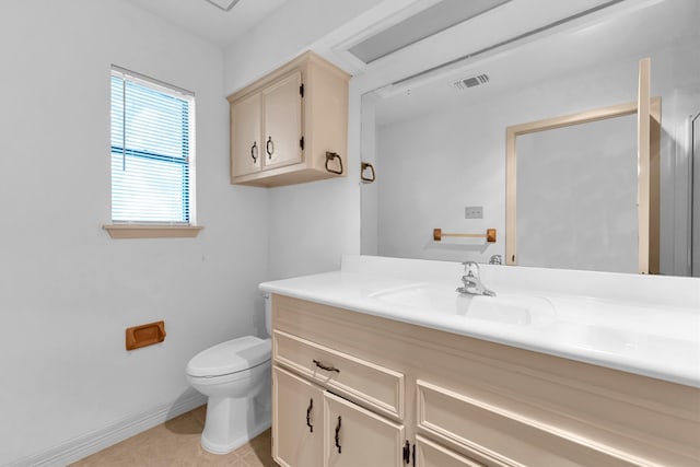 bathroom with vanity, tile patterned flooring, and toilet