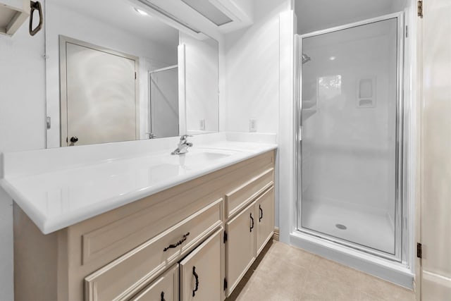 bathroom featuring tile patterned flooring, vanity, and an enclosed shower