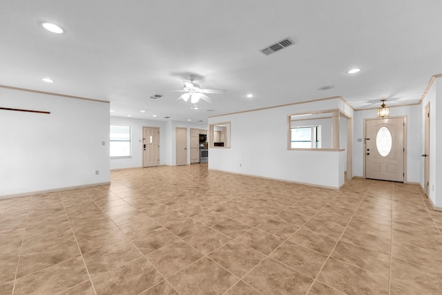 unfurnished living room featuring ceiling fan, a healthy amount of sunlight, and crown molding