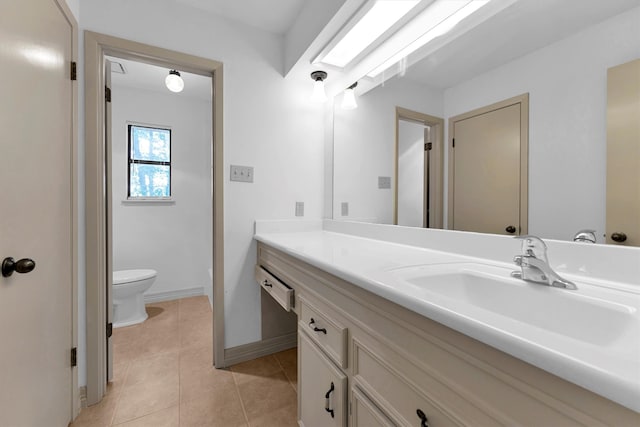 bathroom featuring vanity, tile patterned flooring, and toilet