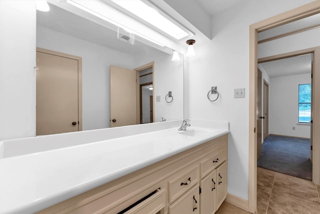 bathroom featuring tile patterned flooring and vanity