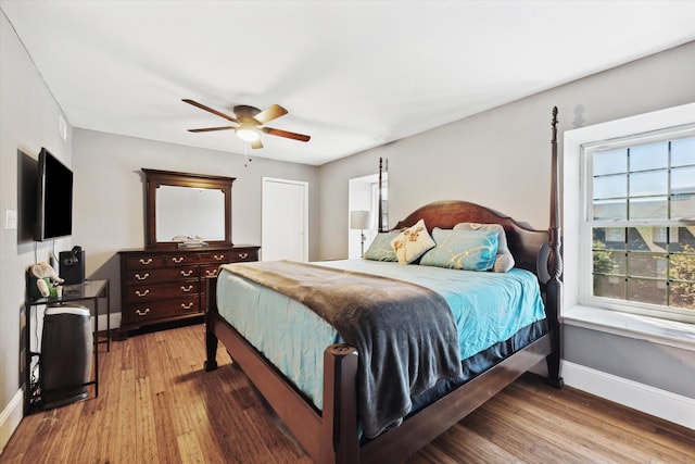 bedroom with ceiling fan and hardwood / wood-style flooring