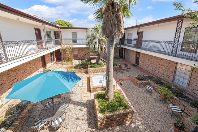 view of pool with a patio and a jacuzzi