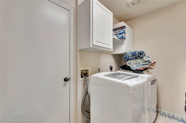 laundry area featuring cabinets and washing machine and dryer