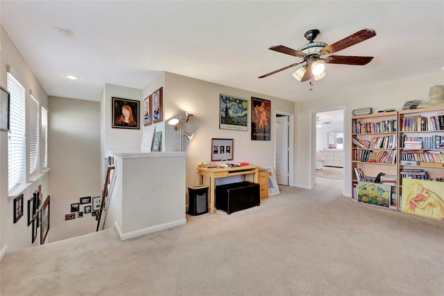 misc room with ceiling fan and light colored carpet