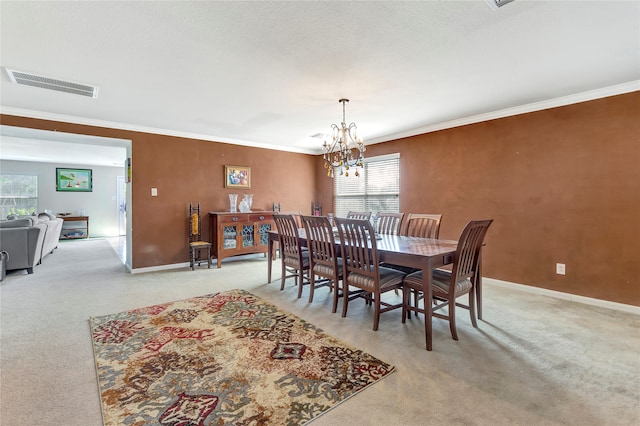 dining room featuring light carpet, plenty of natural light, crown molding, and a notable chandelier