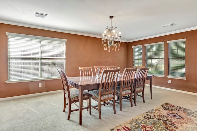 carpeted dining area with crown molding and an inviting chandelier