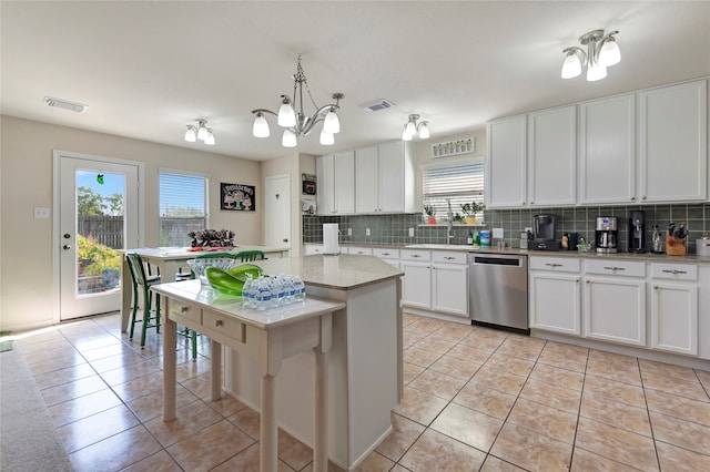 kitchen with white cabinets, decorative light fixtures, an inviting chandelier, dishwasher, and a center island