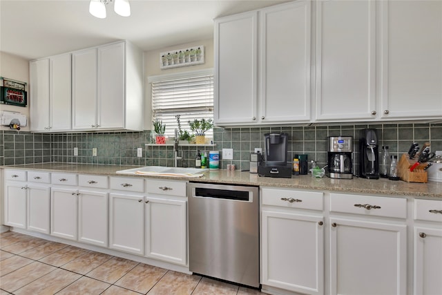 kitchen featuring white cabinetry, dishwasher, light tile patterned flooring, and sink