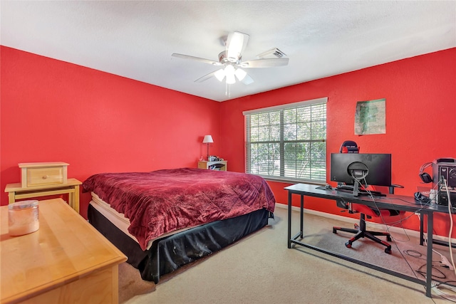 carpeted bedroom with a textured ceiling and ceiling fan