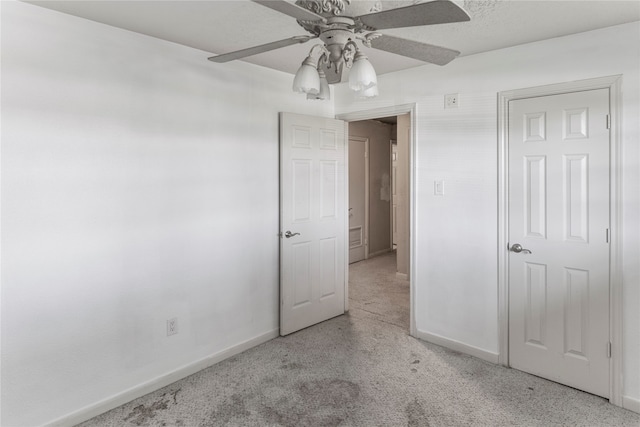 unfurnished bedroom with light carpet and ceiling fan