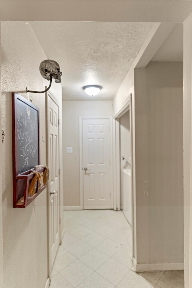 hallway with a textured ceiling