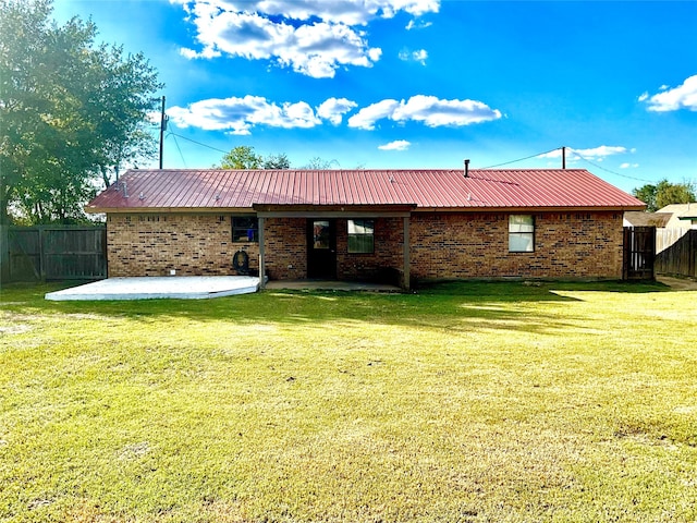 back of house with a yard and a patio area