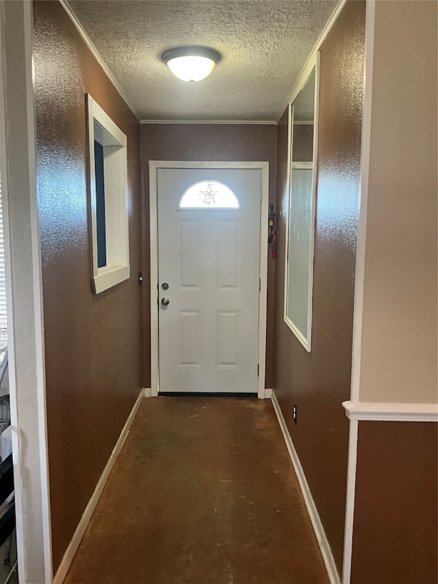 entryway featuring a textured ceiling and crown molding