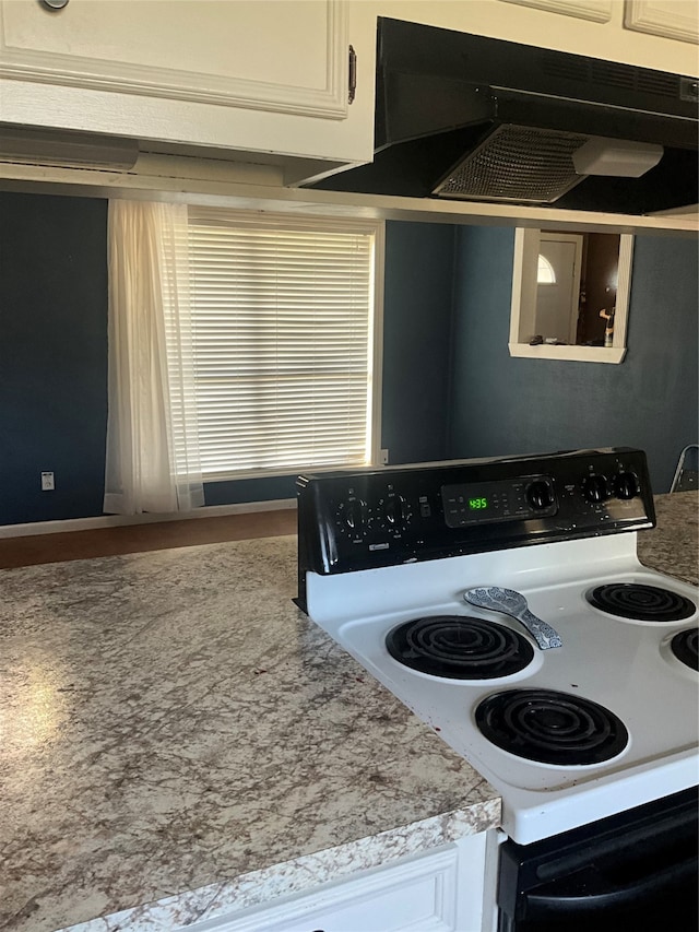 kitchen with white cabinets, white electric range oven, and ventilation hood