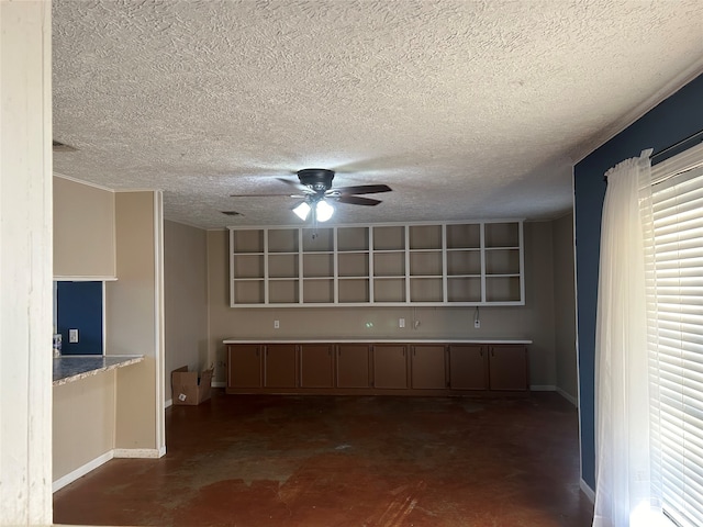 kitchen with a textured ceiling and ceiling fan