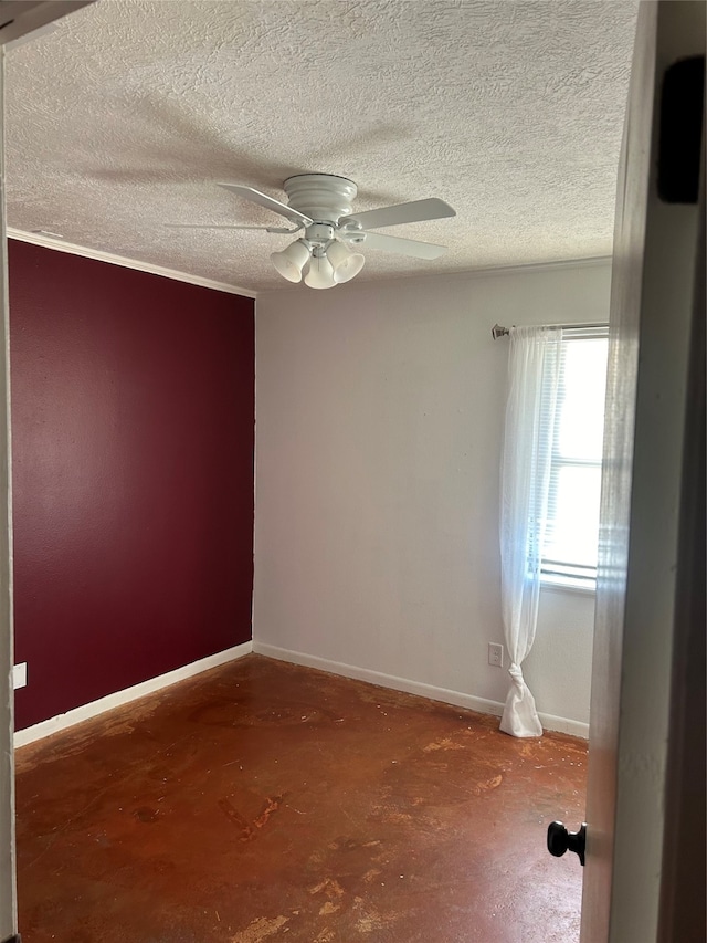 empty room featuring a textured ceiling, crown molding, ceiling fan, and concrete flooring