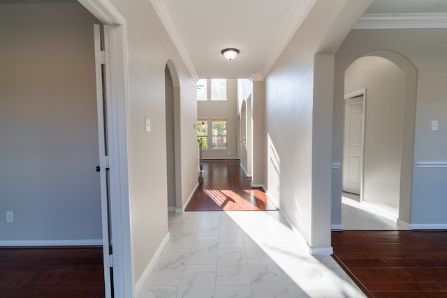 hall with light hardwood / wood-style flooring and crown molding