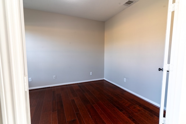 empty room with dark hardwood / wood-style floors