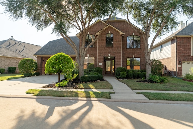 view of front of home with a garage and a front lawn