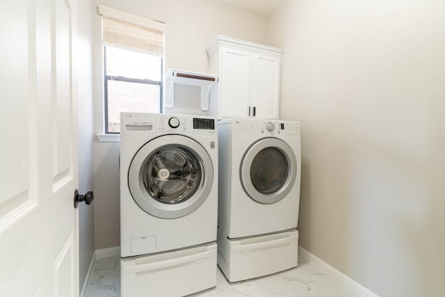 clothes washing area with washing machine and clothes dryer